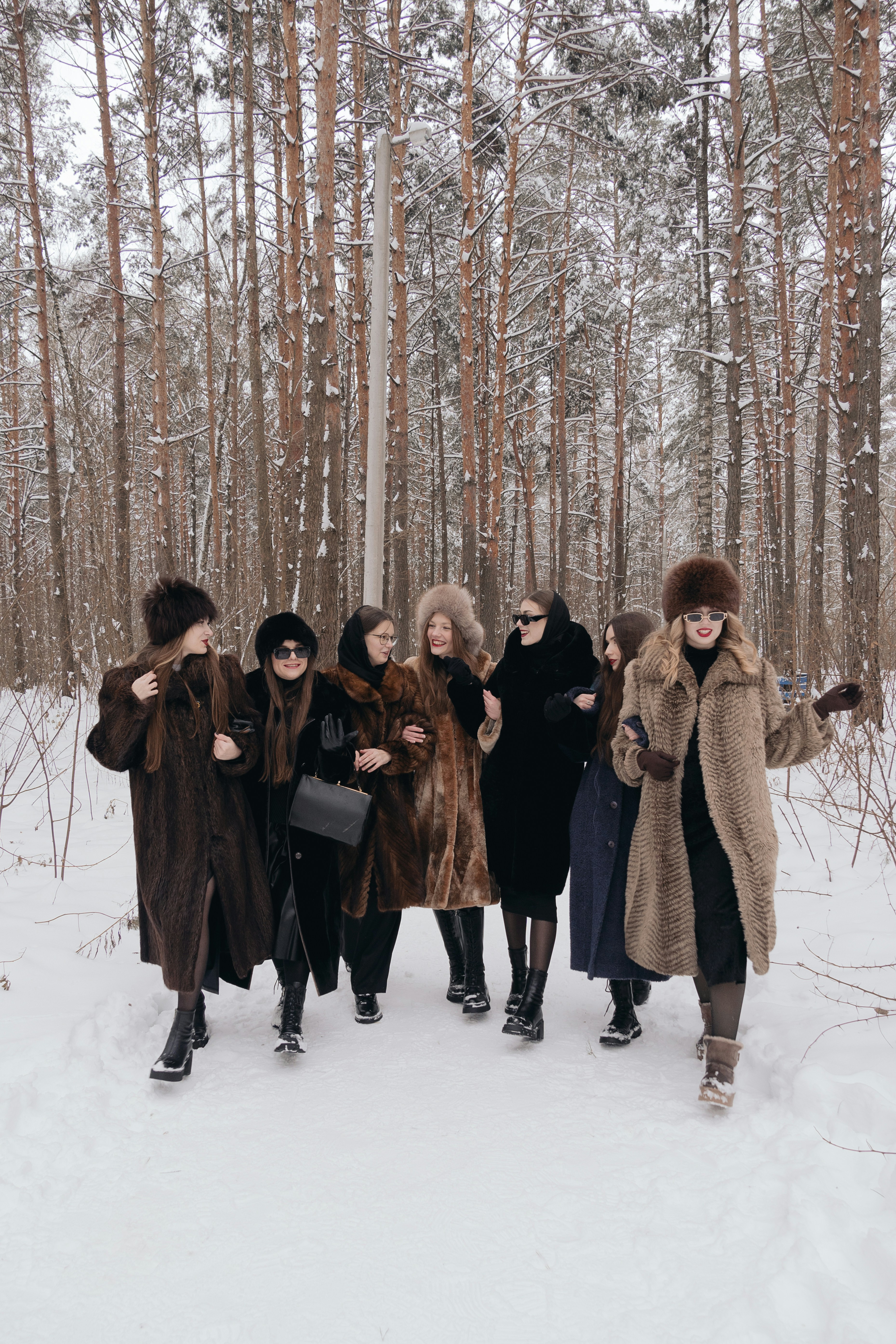 a group of people standing next to each other in the snow