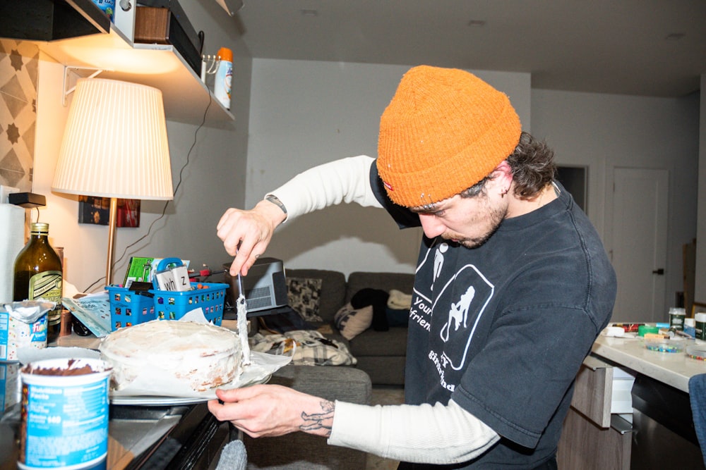 a man cutting a cake with a knife