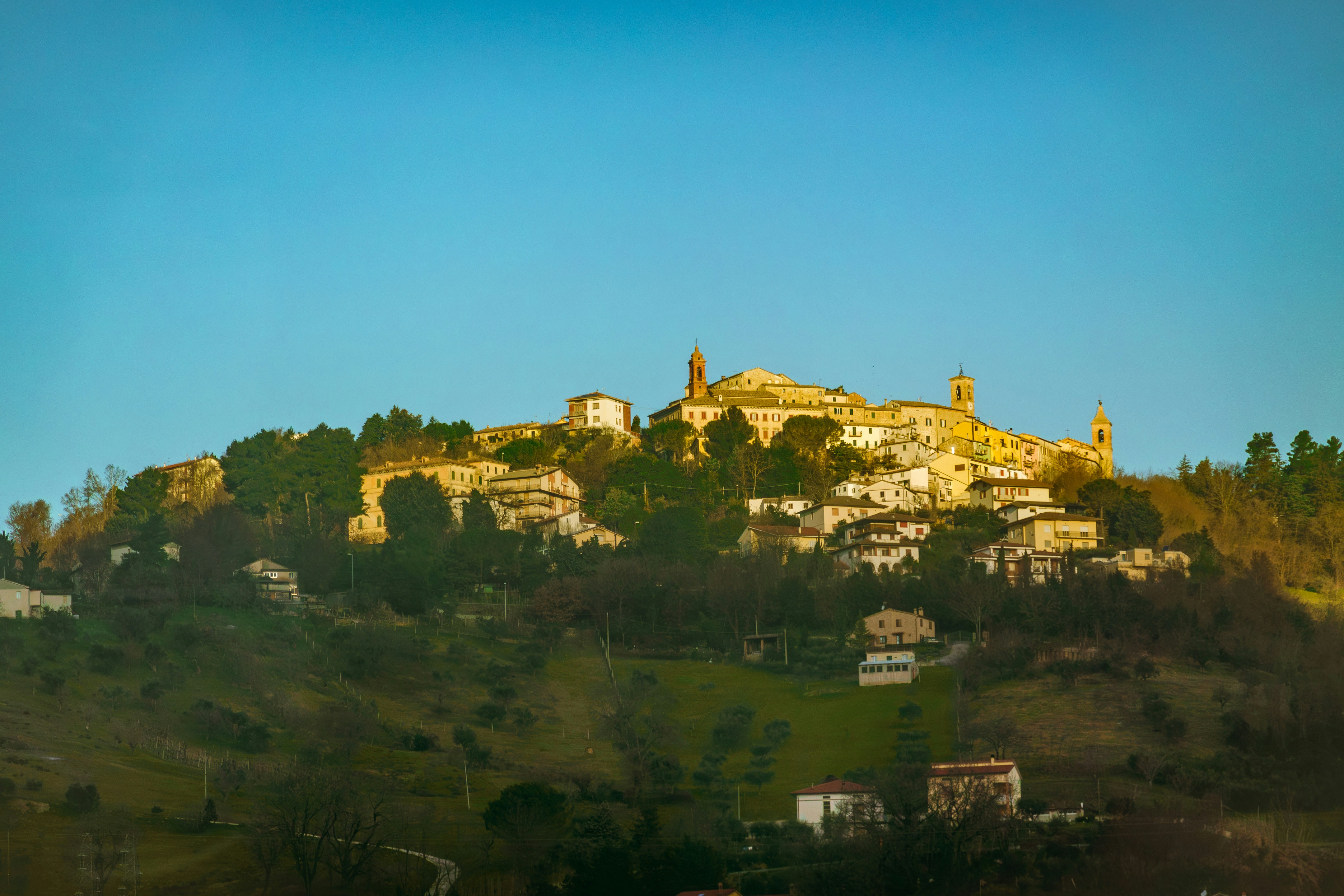 a hill with a village on top of it, Monte Roberto, nestled in Italy
