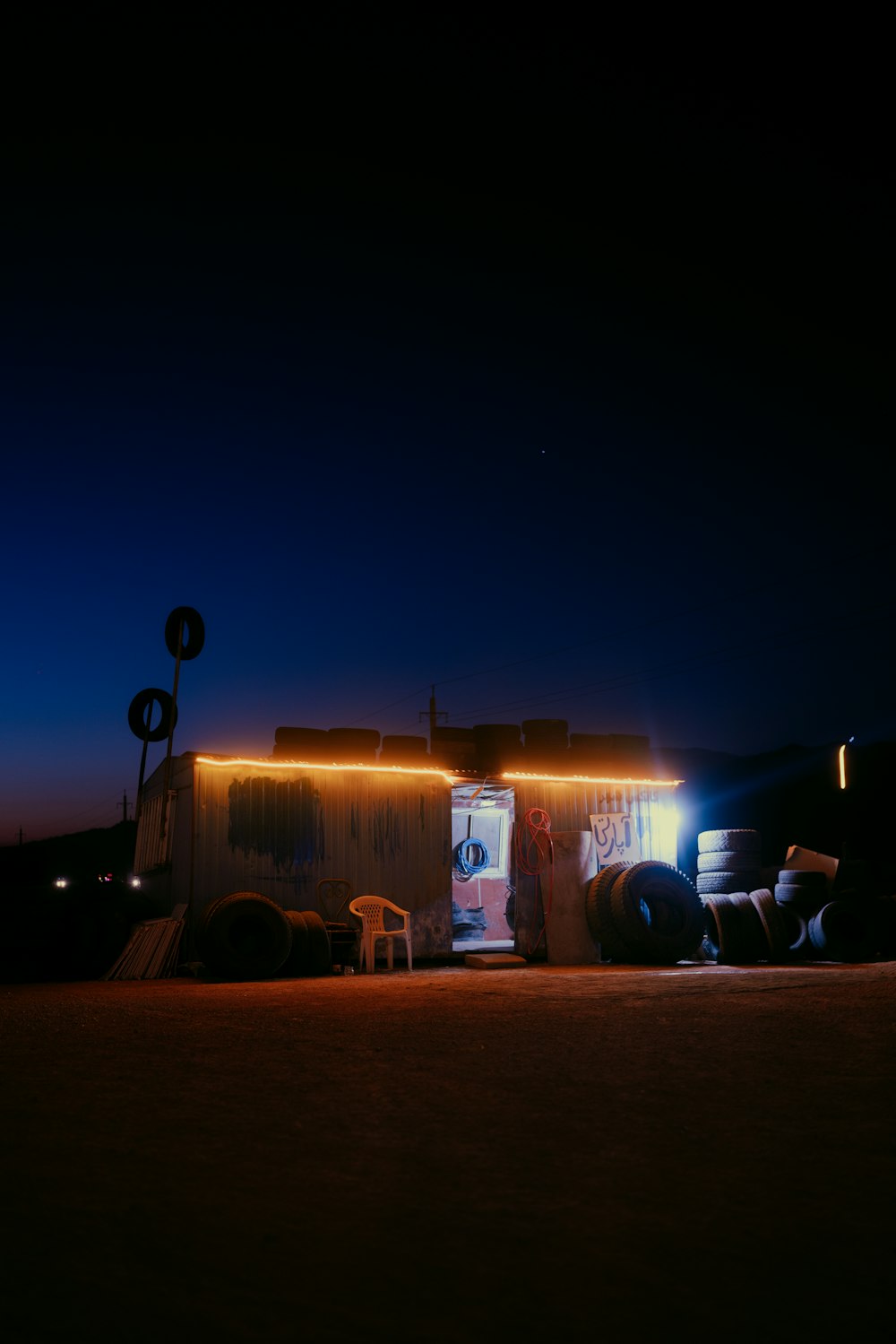 a truck parked in front of a building at night