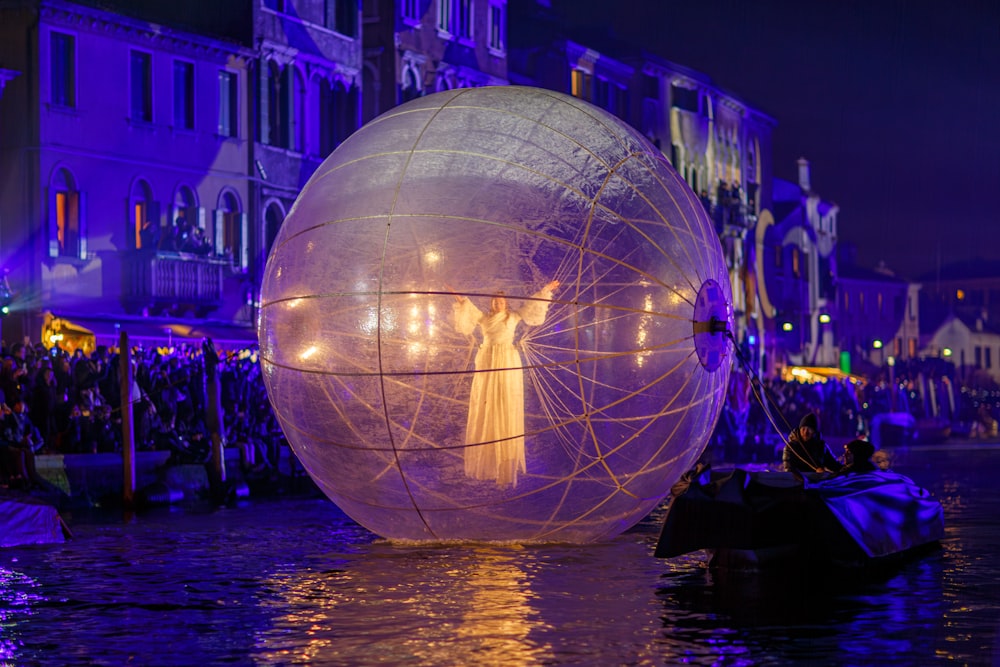 a large white ball floating on top of a body of water