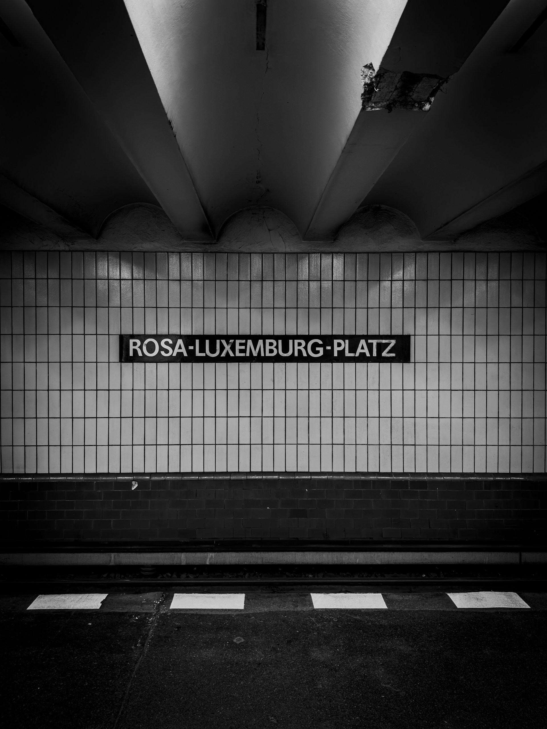 a black and white photo of a subway station