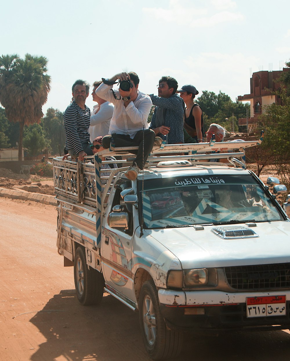 a group of men standing in the back of a truck