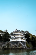 a large white building sitting on top of a lake