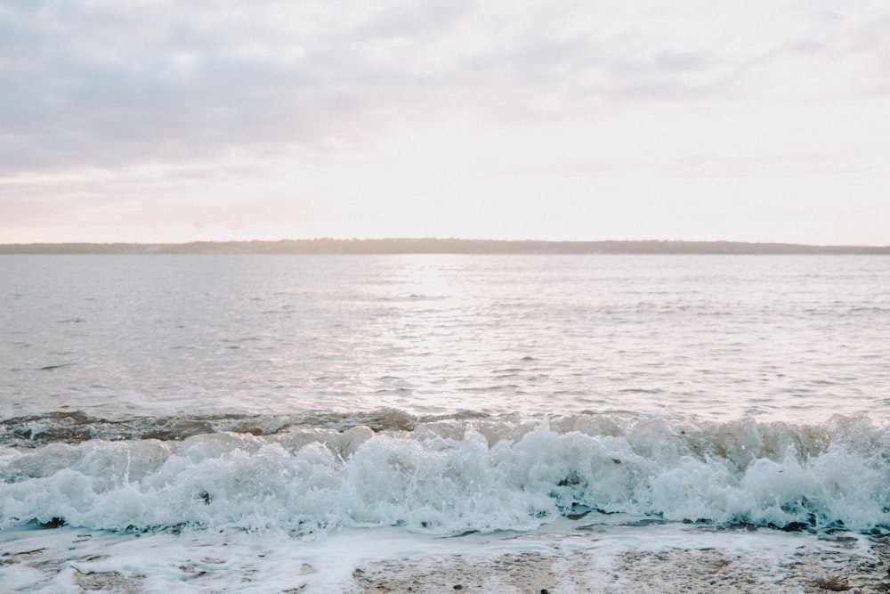 a body of water with waves coming in to shore