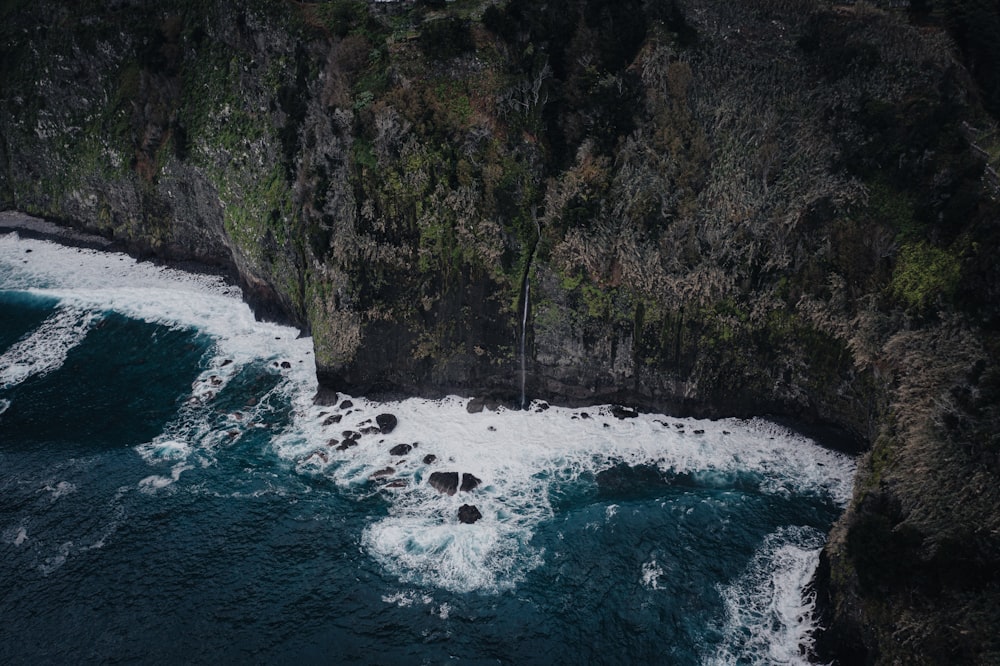 an aerial view of a body of water near a cliff