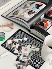 an open book sitting on top of a table next to a cup of coffee