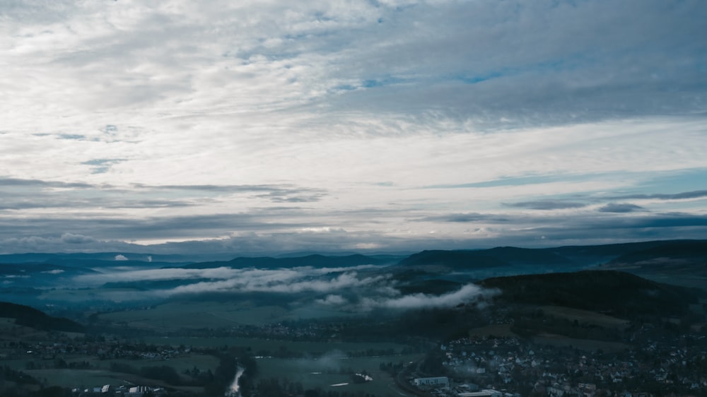 a scenic view of a valley with clouds in the sky