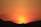 the sun is setting over a mountain range