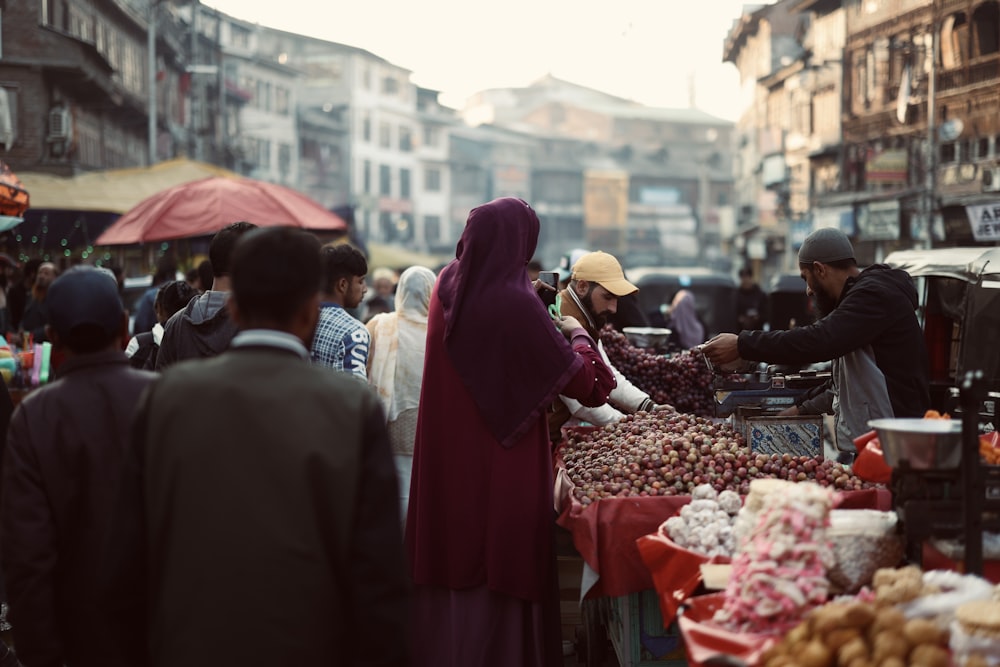 a group of people standing around a market
