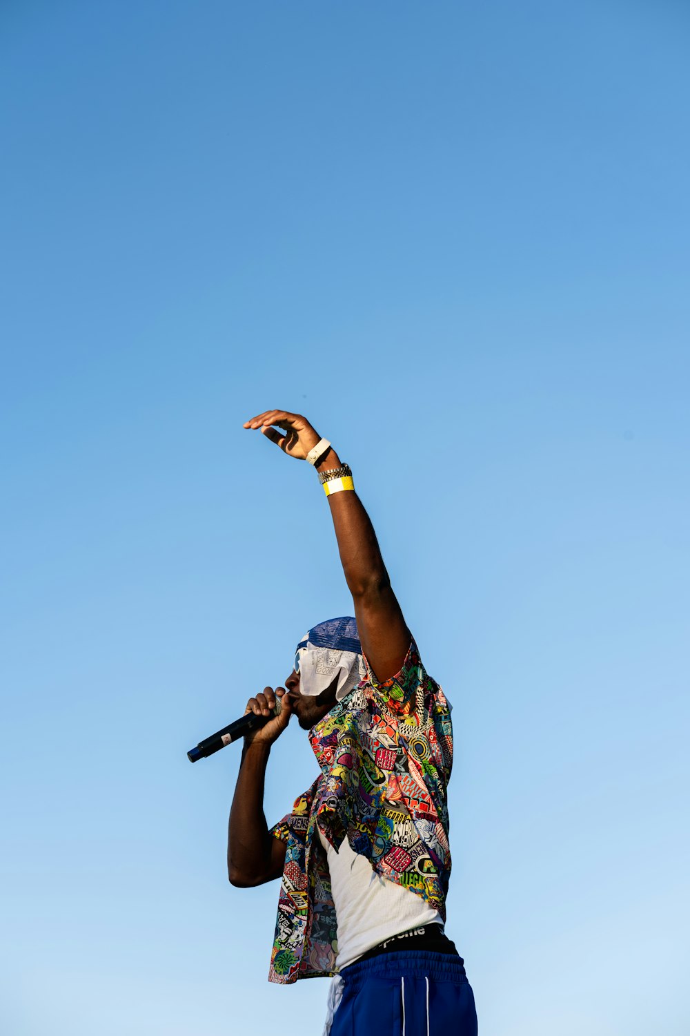 a man holding a microphone up in the air