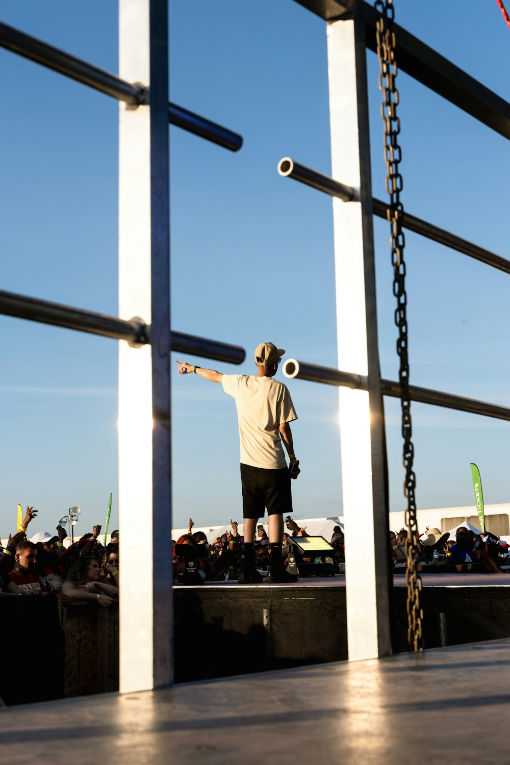 a man standing on a stage with a ball in the air