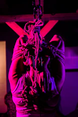 a woman hanging from a rope in a room