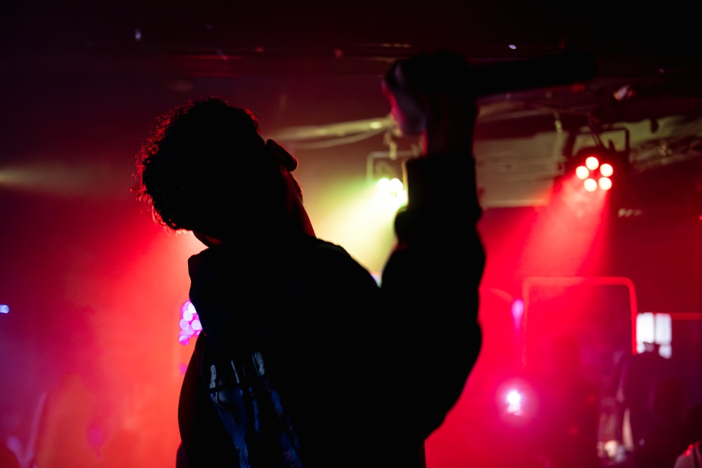 a person standing in front of red and green lights