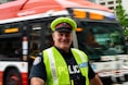 a police officer standing in front of a bus