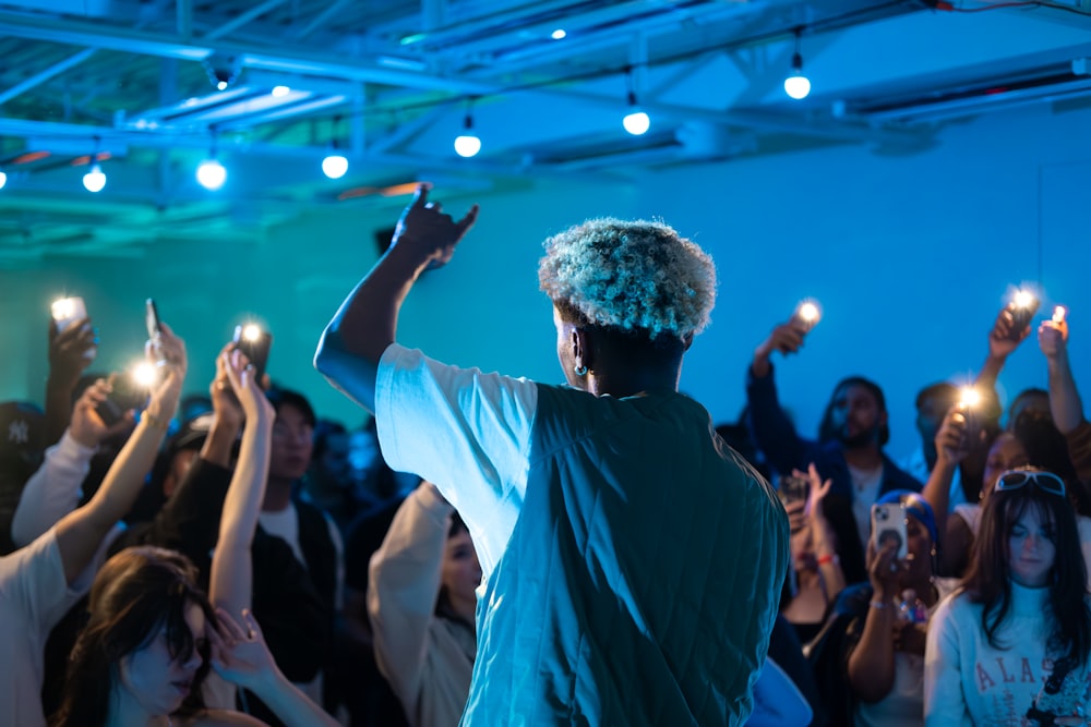 a group of people holding up their cell phones