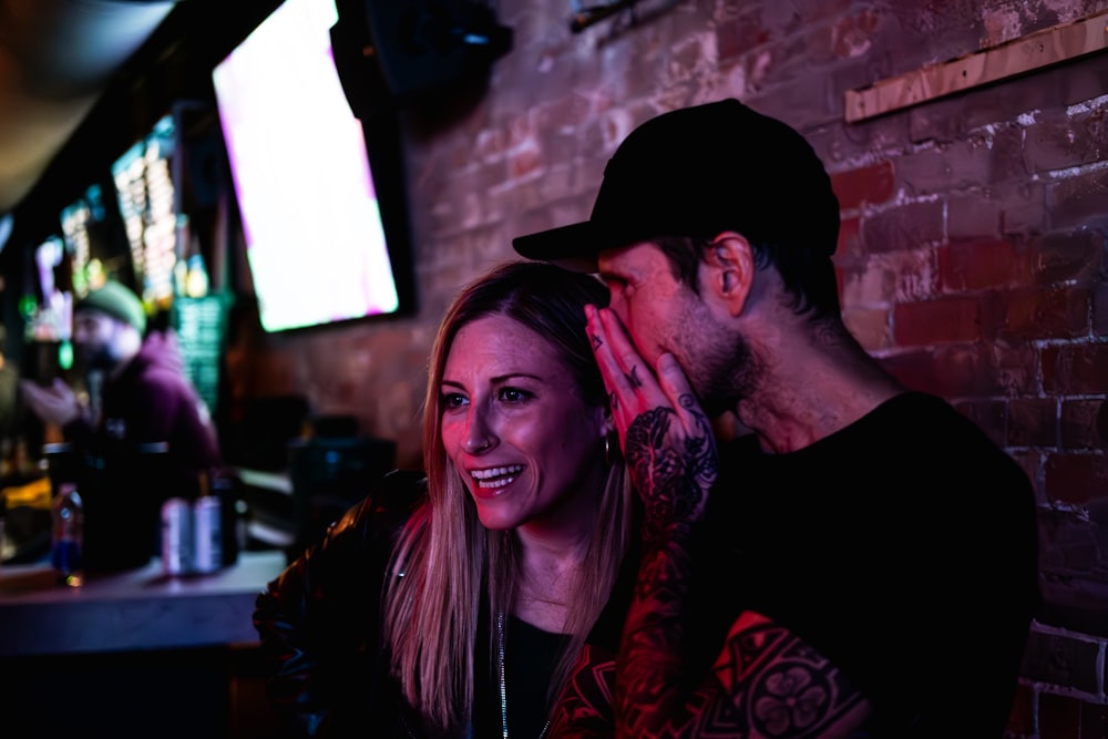 a man and a woman sitting at a bar