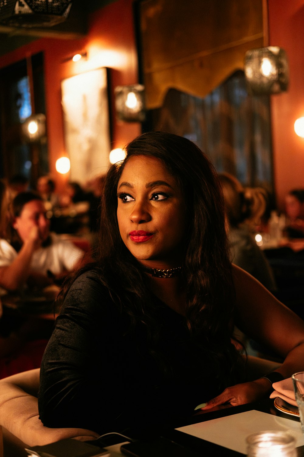 a woman sitting at a table in a restaurant