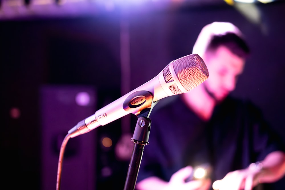 a man playing a keyboard in front of a microphone