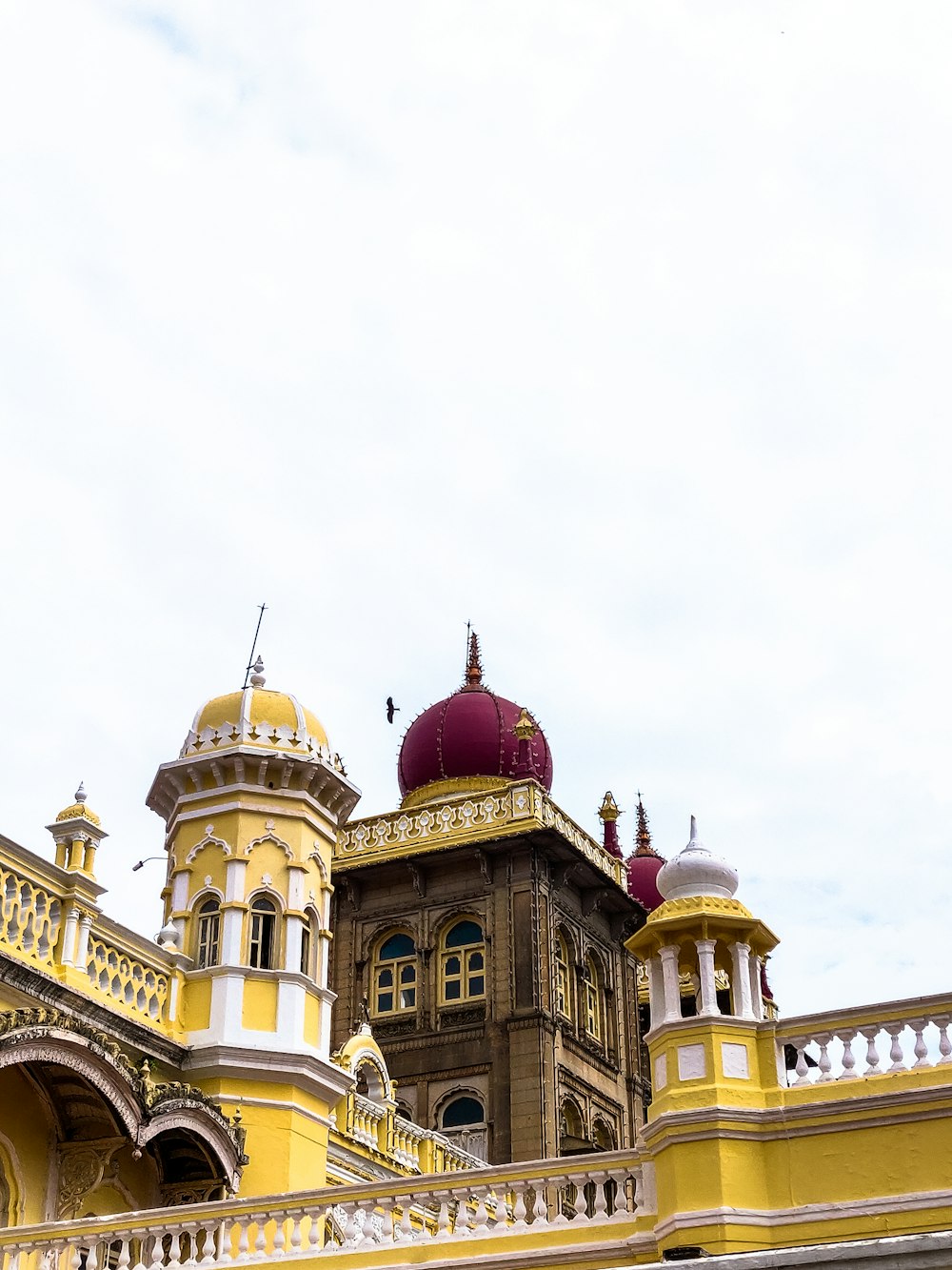 a yellow and white building with a red dome