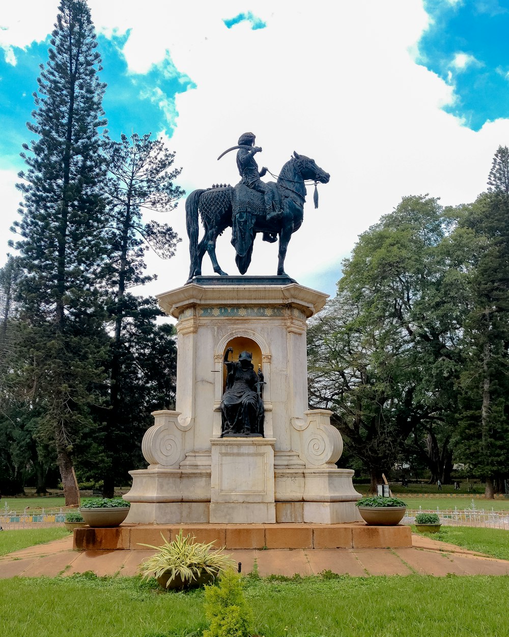 a statue of a man on a horse in a park