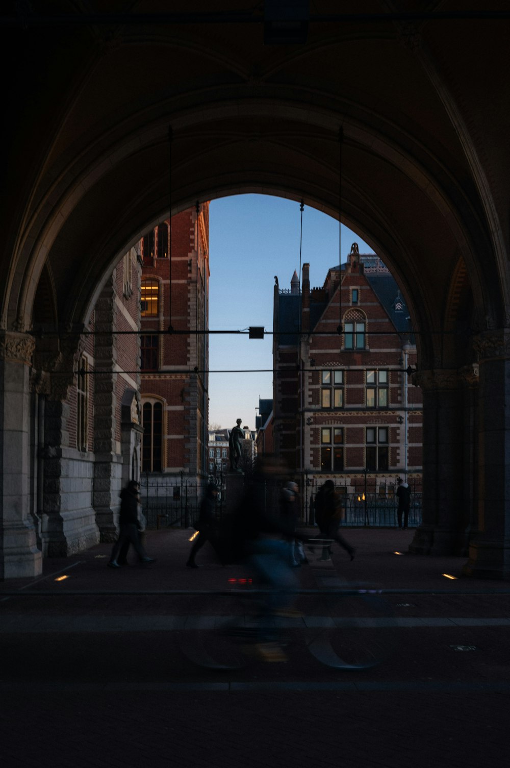 a person riding a bike through a tunnel