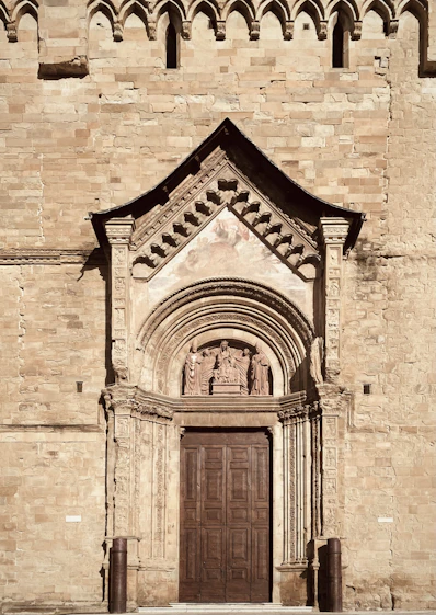 a very tall building with a big wooden door