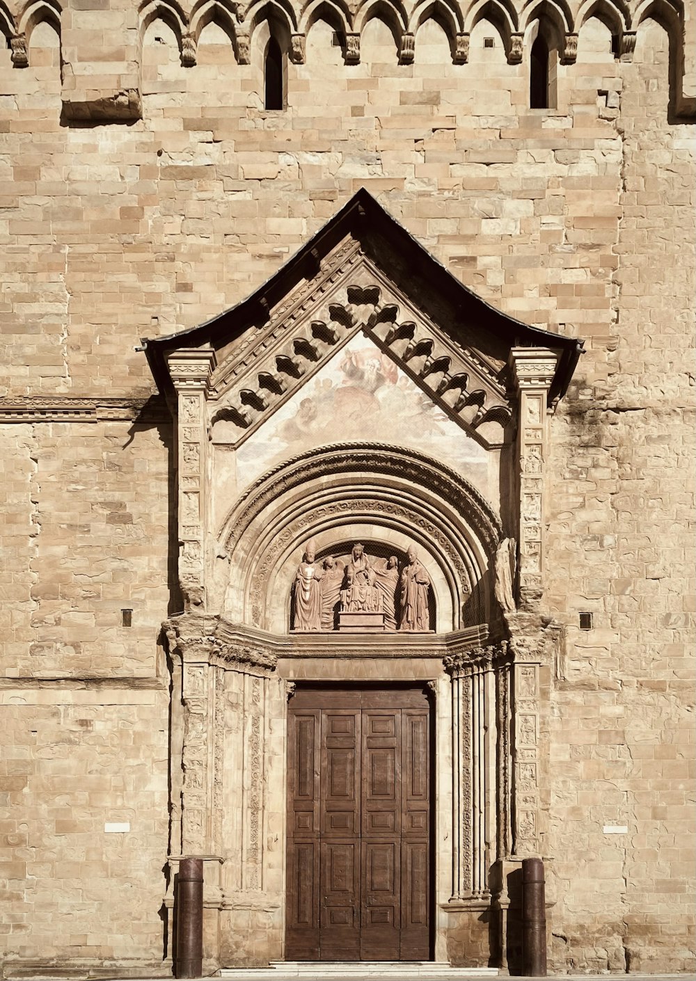 a very tall building with a big wooden door