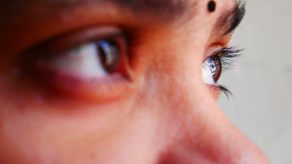 a close up of a person's eye and nose