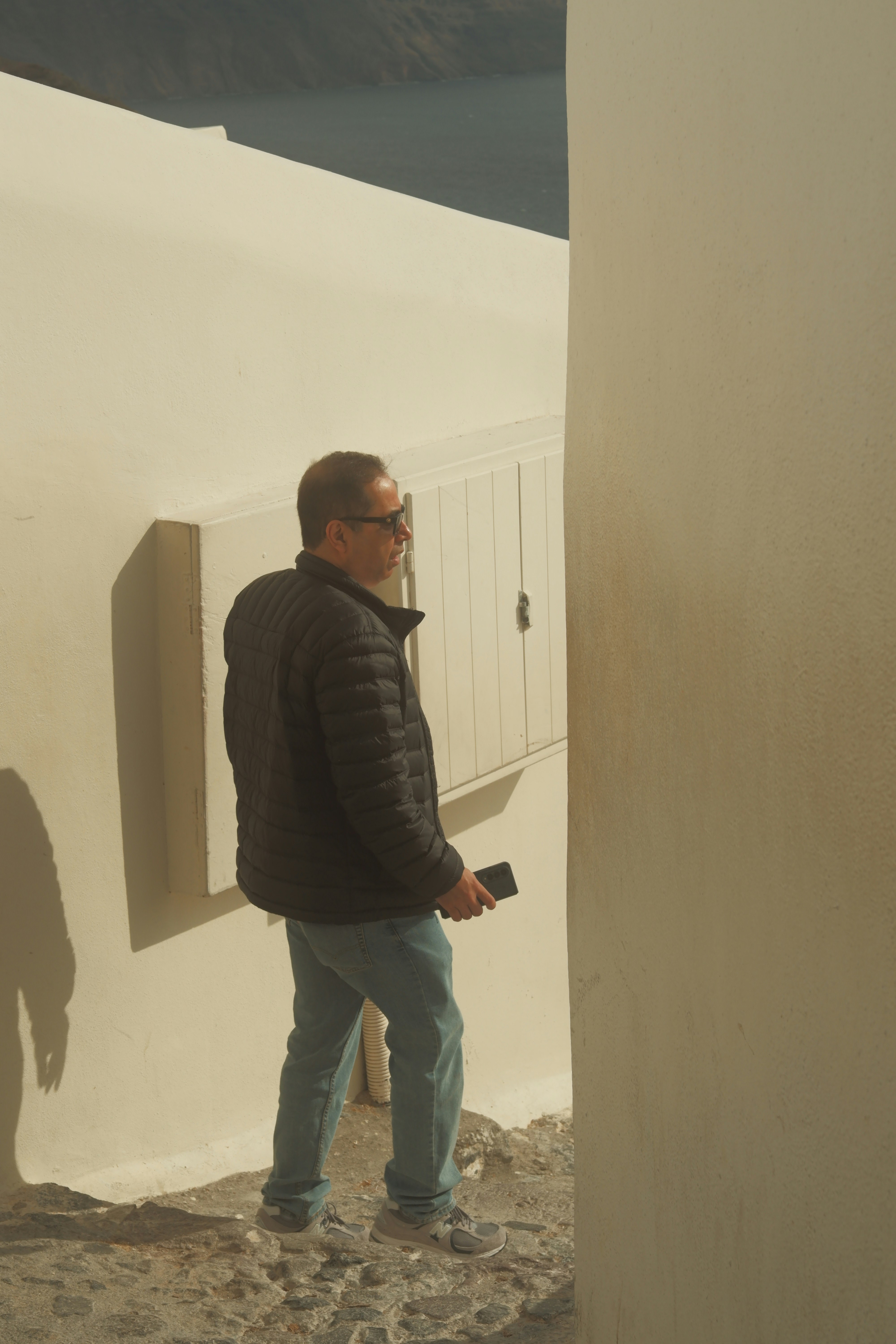 a man standing next to a white building