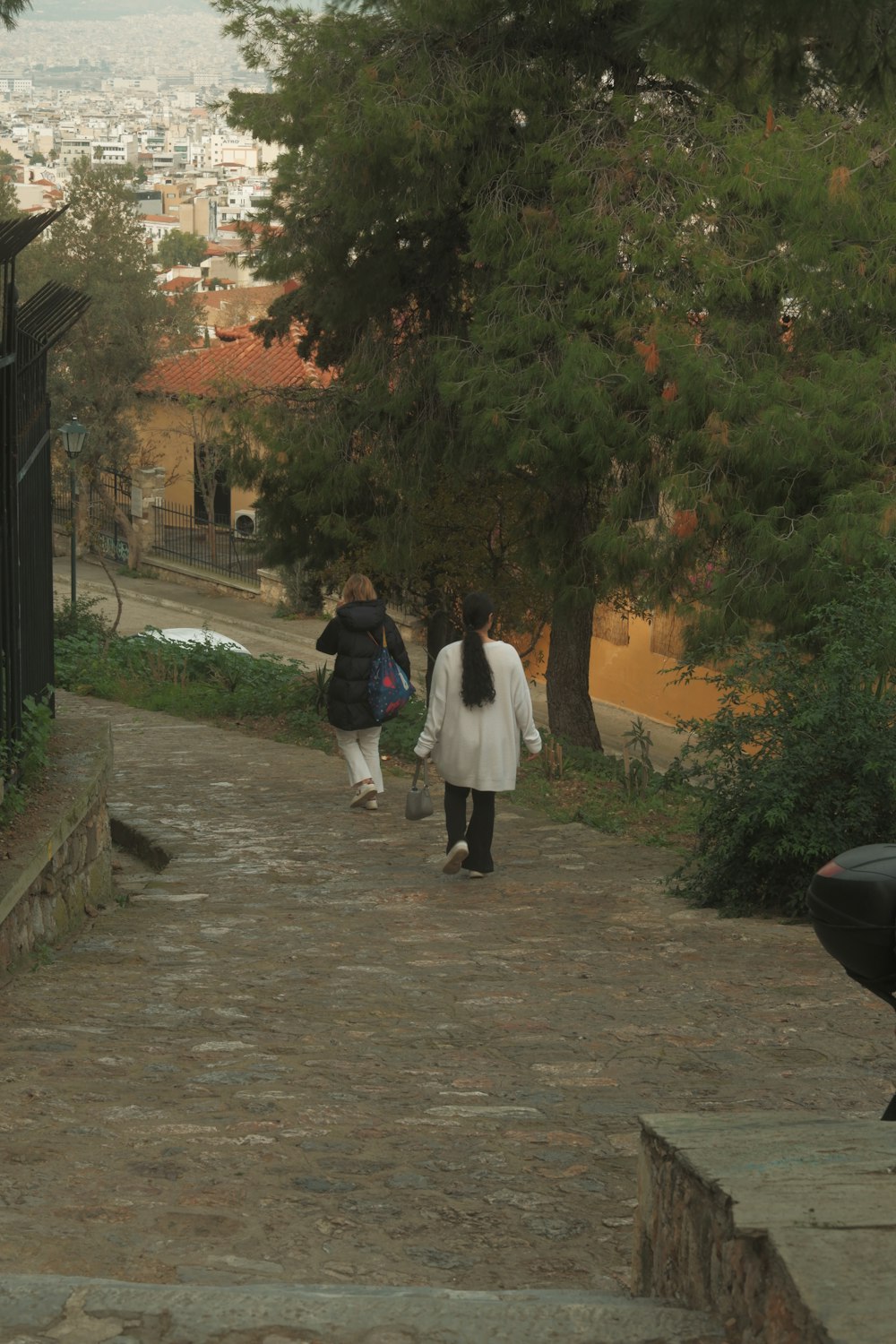 a couple of people walking down a street