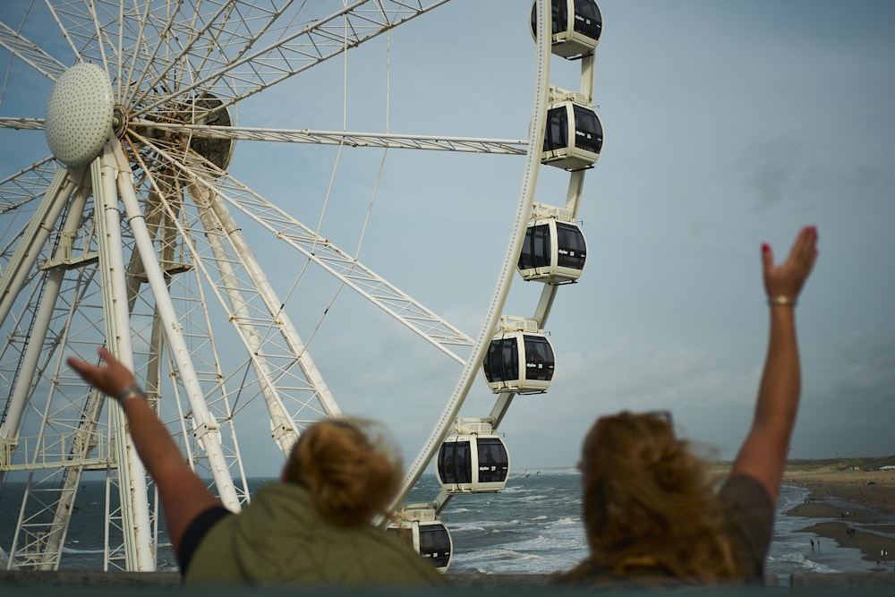a ferris wheel with people watching it