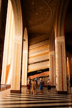 a group of people standing in a large room