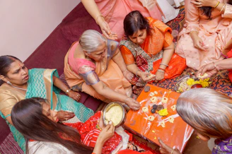 a group of women sitting around each other