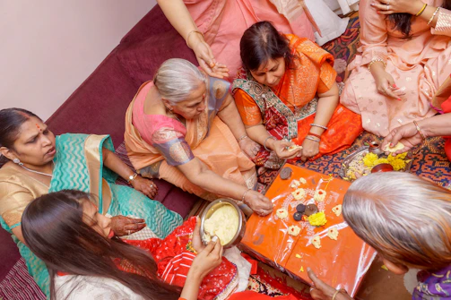 a group of women sitting around each other