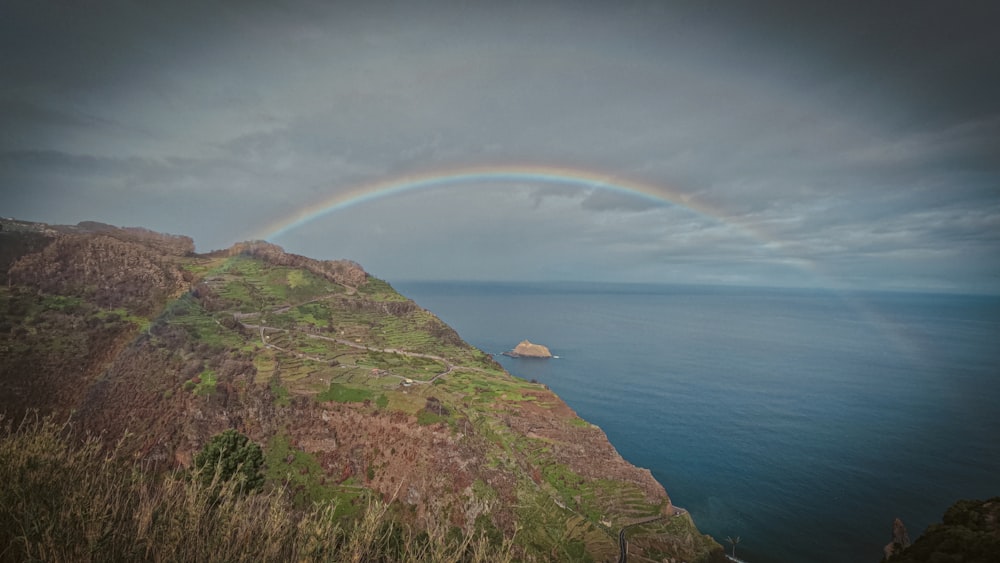 a rainbow in the sky over a body of water