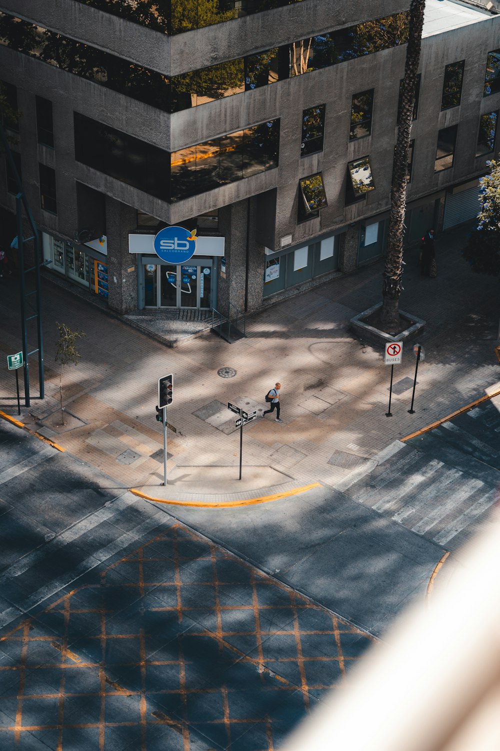 an aerial view of a street corner with a building in the background