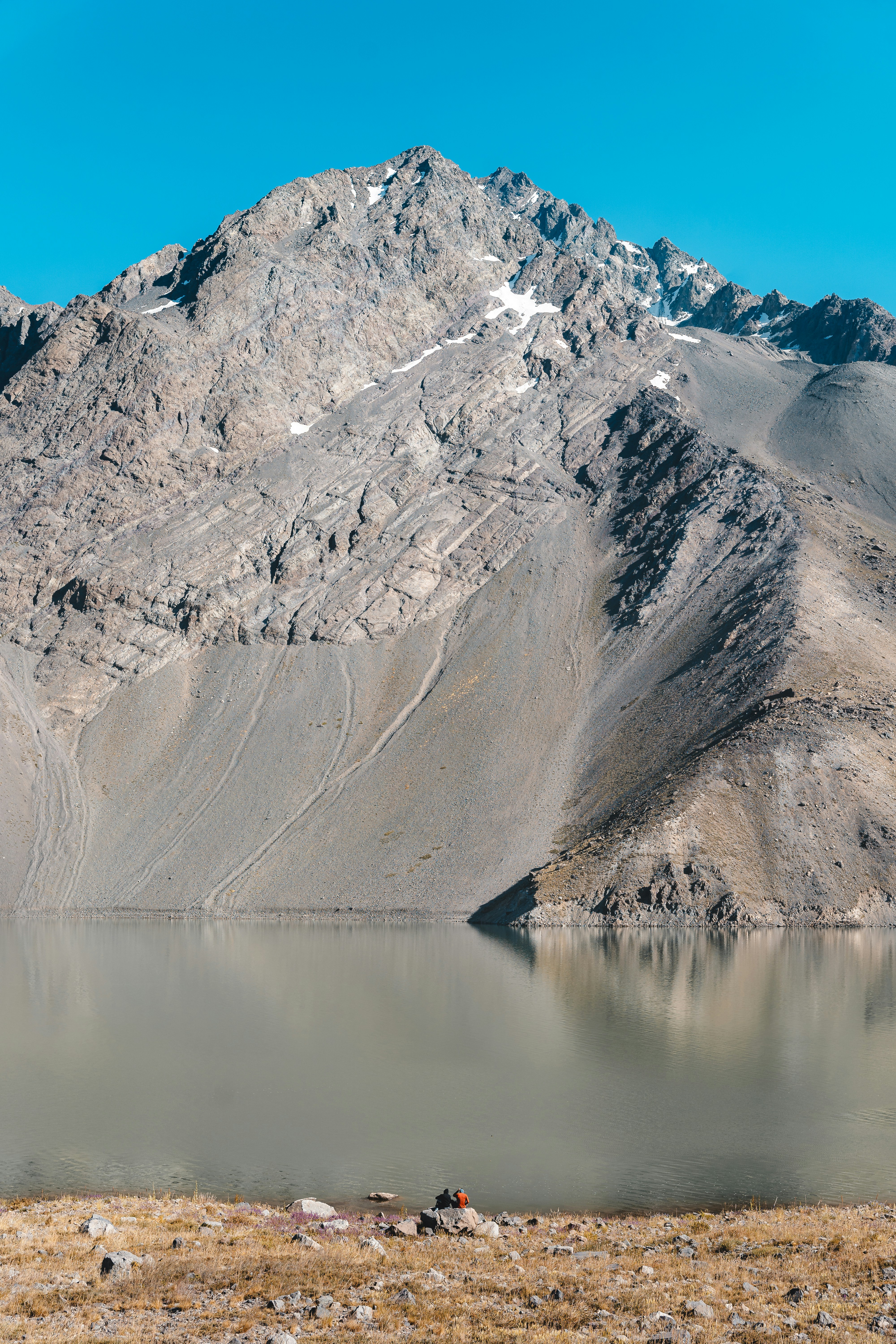 a mountain range with a lake in the foreground