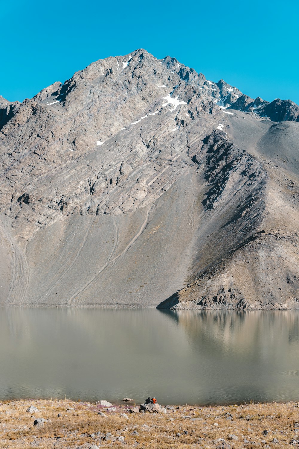 a mountain range with a lake in the foreground