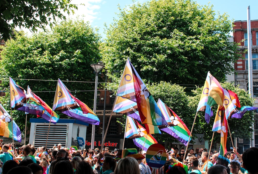 a large group of people holding colorful flags
