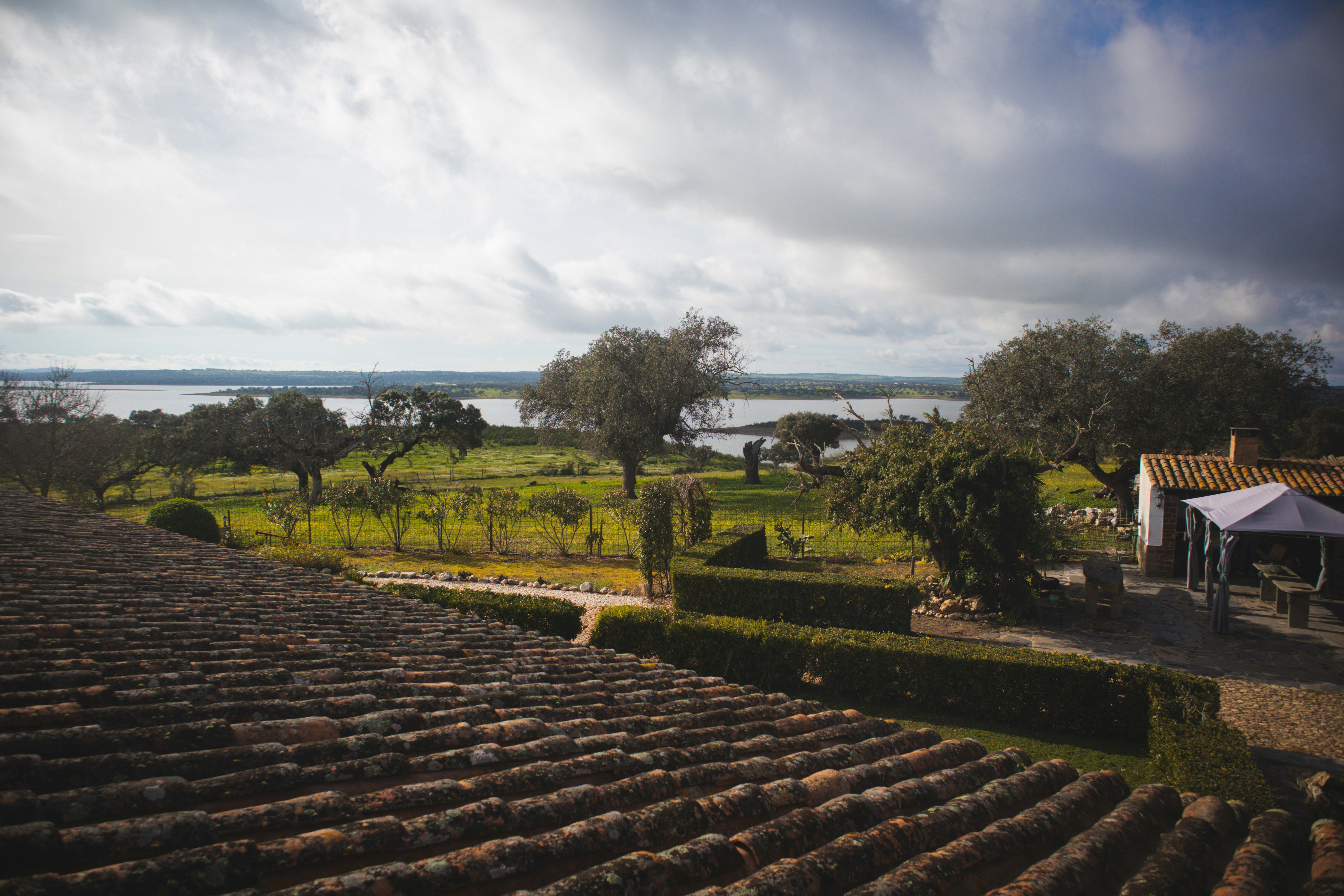 a view of a field and a lake from a roof