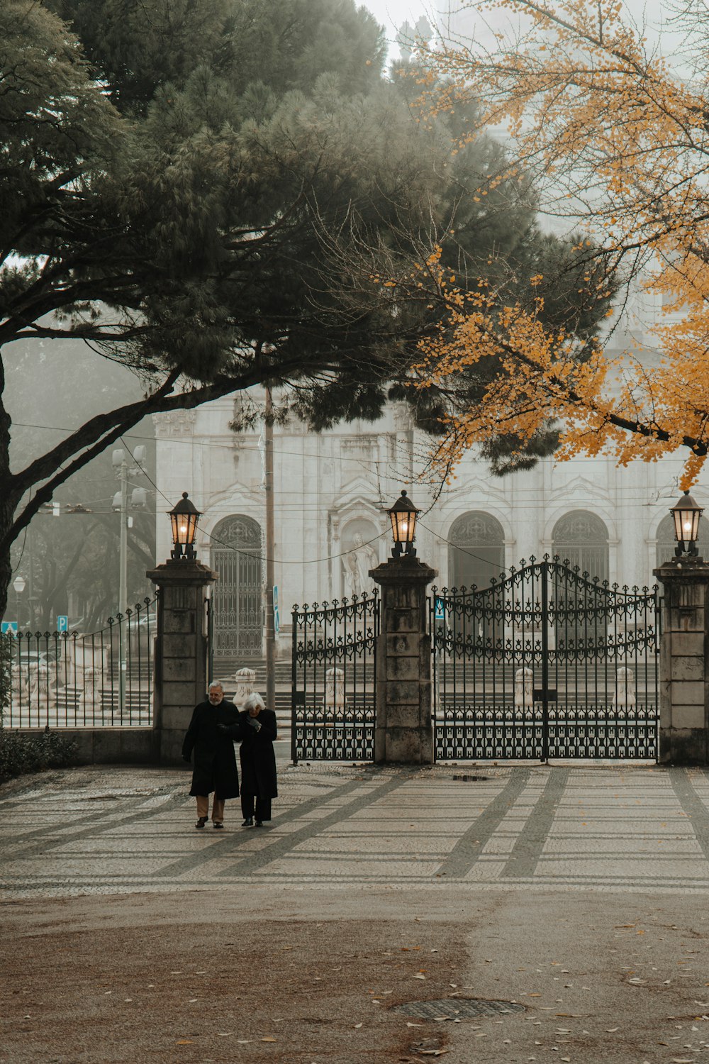 a couple of people that are standing in front of a gate