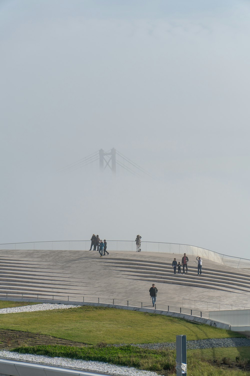 a group of people walking on a foggy day