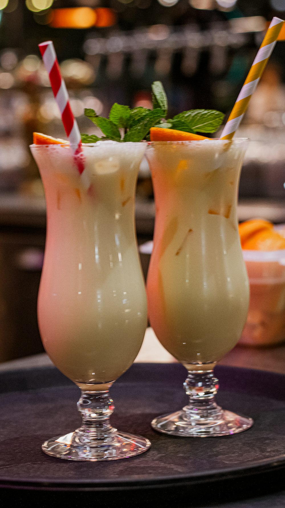 a couple of glasses filled with drinks on top of a table