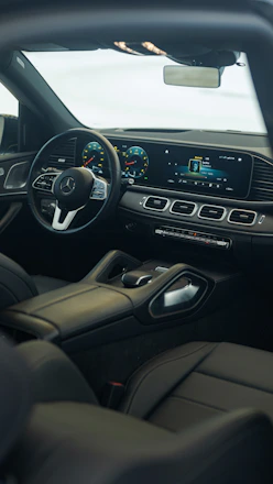 the interior of a car with a steering wheel and dashboard