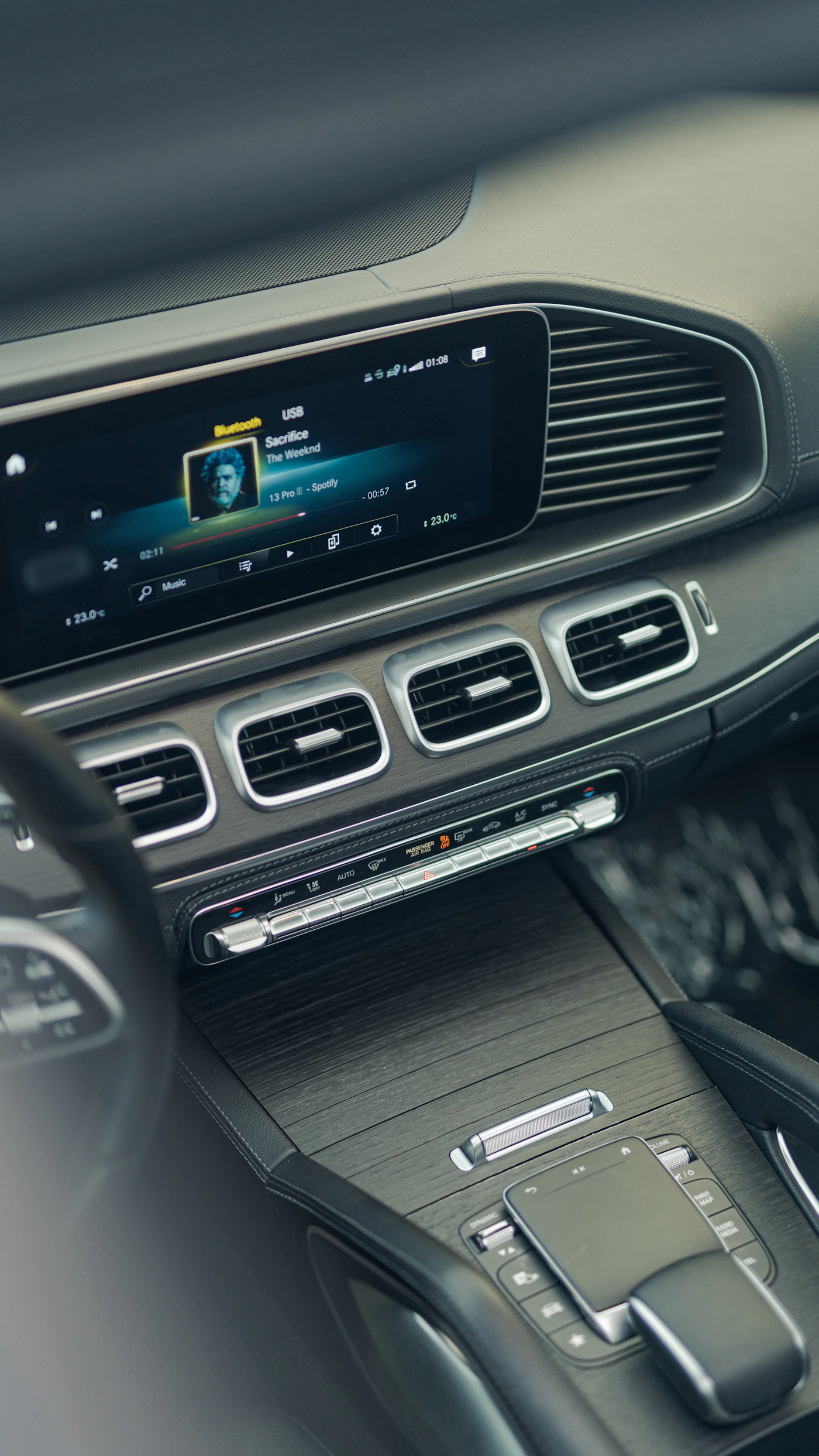 Close view of an in-car touchscreen and automotive electronic controls