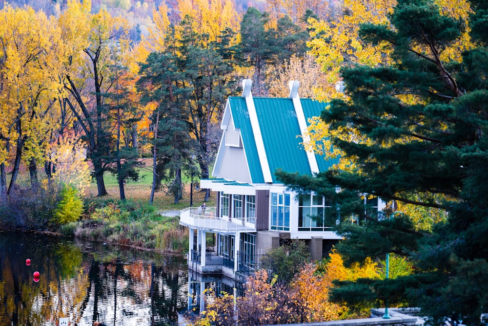 a house on a lake surrounded by trees