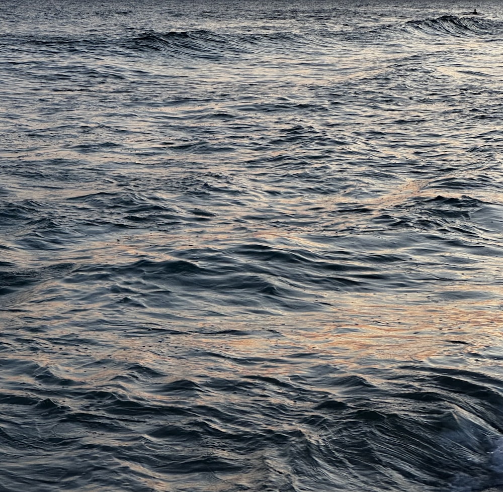 a man riding a surfboard on top of a wave in the ocean