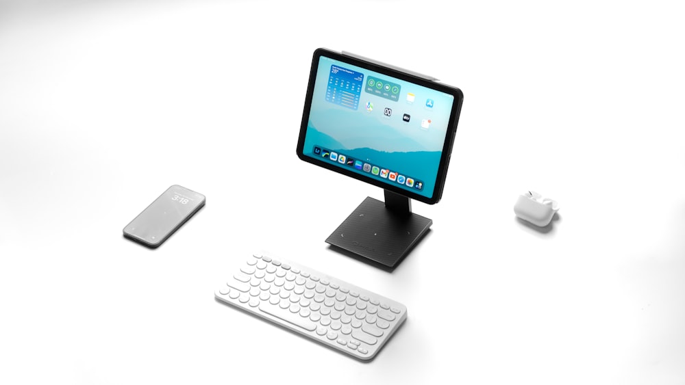 a computer monitor sitting on top of a desk next to a keyboard