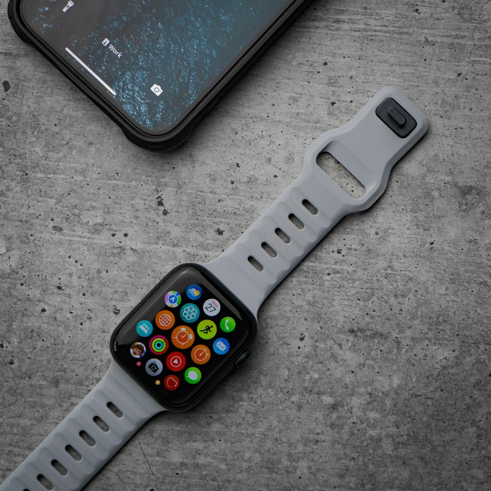 a smart watch sitting next to an iphone